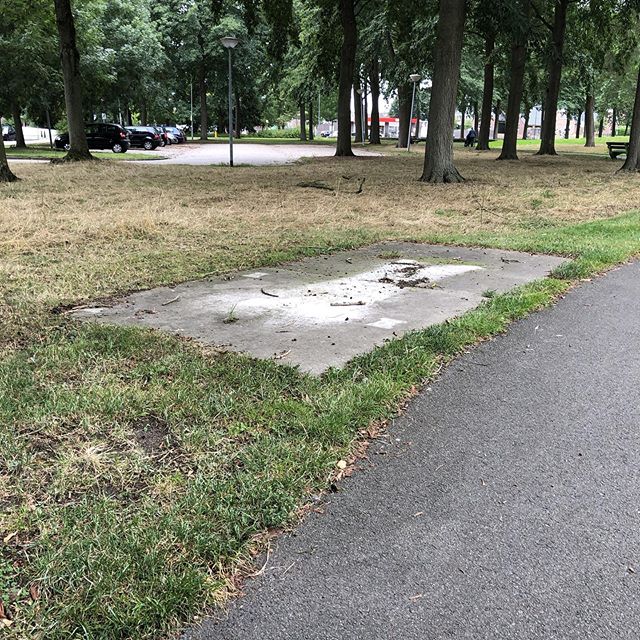 public place with concrete slab where there used to be a bench